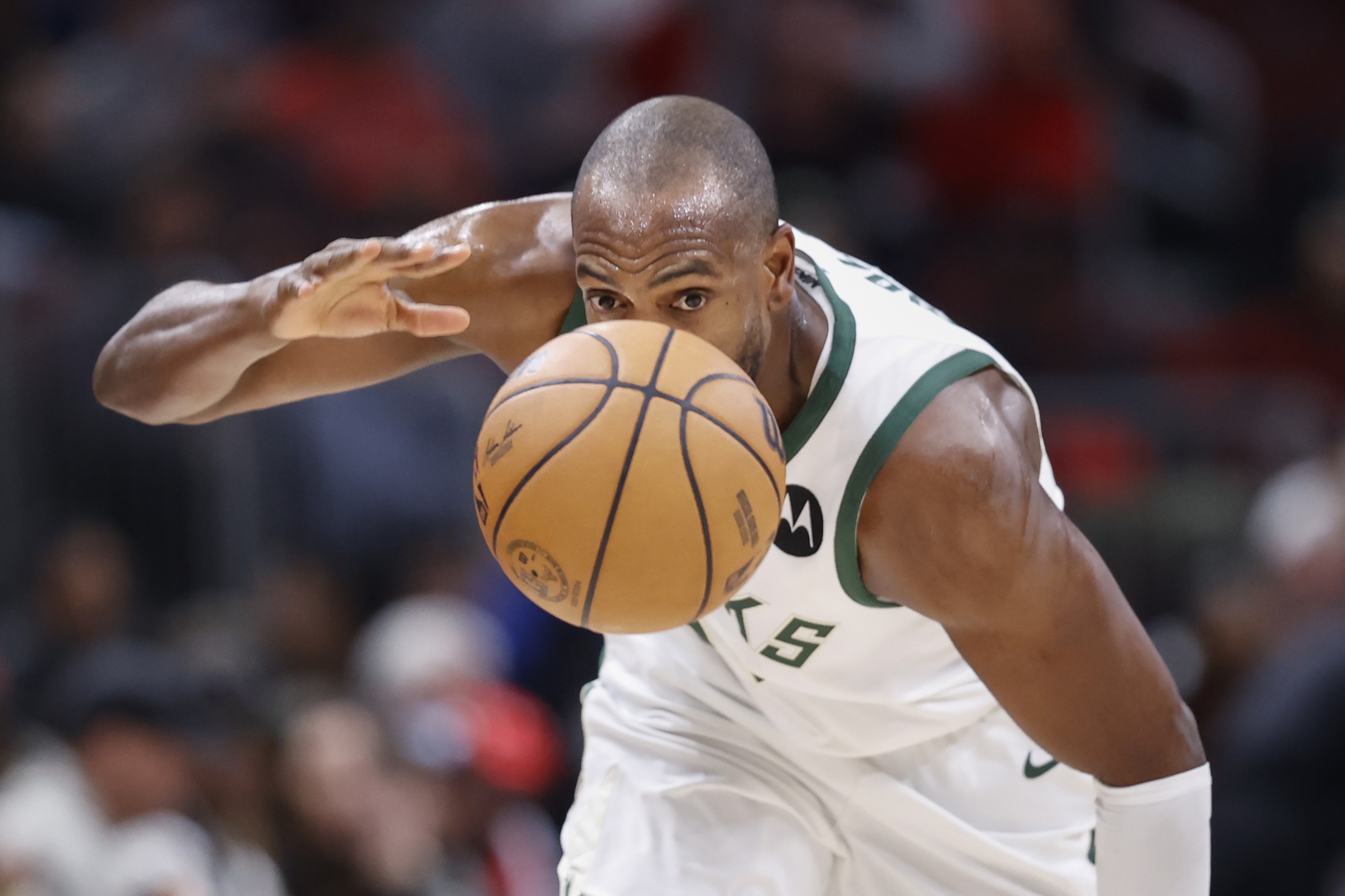 Milwaukee Bucks forward Khris Middleton (22) goes after the ball 